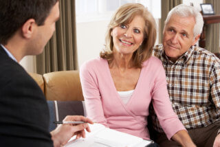 senior couple talking with advisor